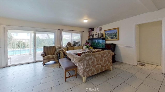 living room featuring a wealth of natural light and light tile patterned floors