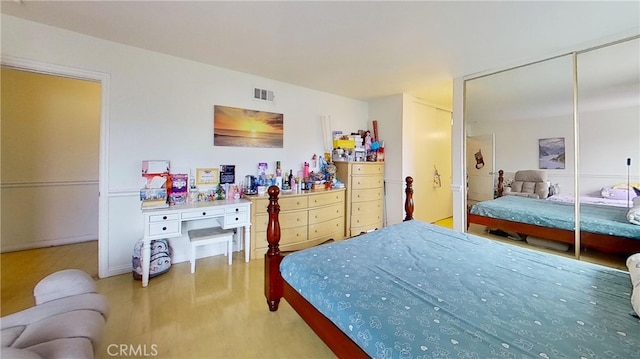 bedroom with a closet and hardwood / wood-style floors