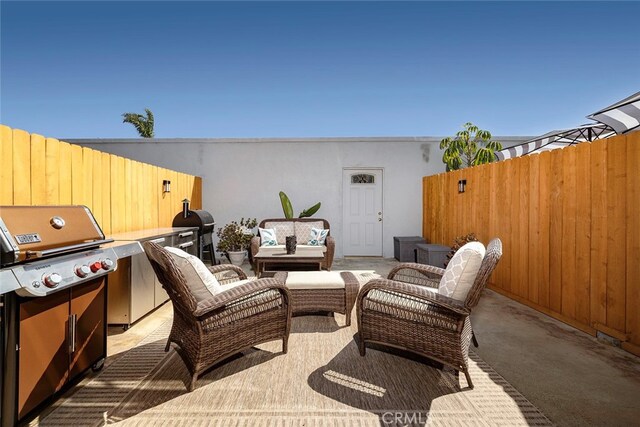 view of patio with outdoor lounge area and a grill