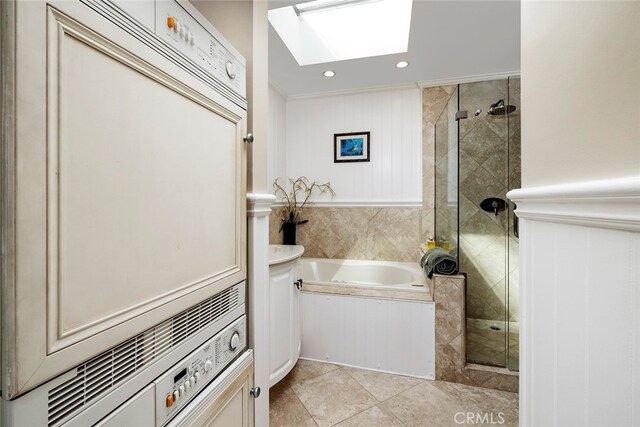 bathroom featuring shower with separate bathtub, tile patterned flooring, ornamental molding, and a skylight