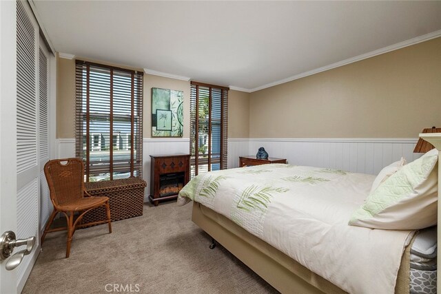 bedroom featuring light carpet, a closet, and crown molding