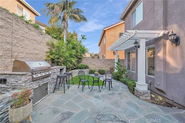 view of patio featuring area for grilling and a pergola