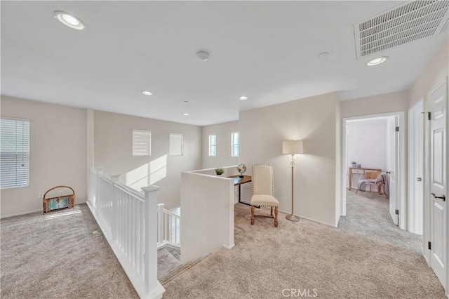 corridor with light colored carpet