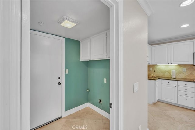 clothes washing area with light tile patterned floors