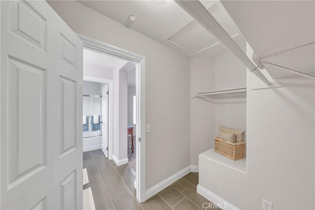 walk in closet with hardwood / wood-style flooring