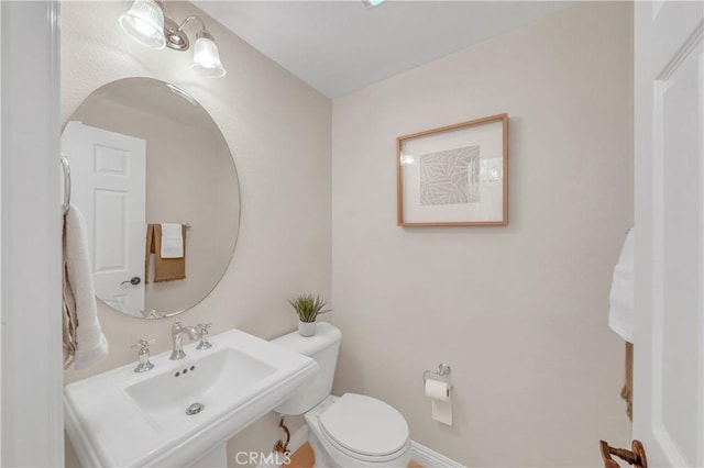 bathroom featuring sink and toilet