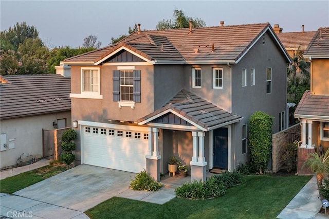 view of front of home featuring a garage and a front lawn