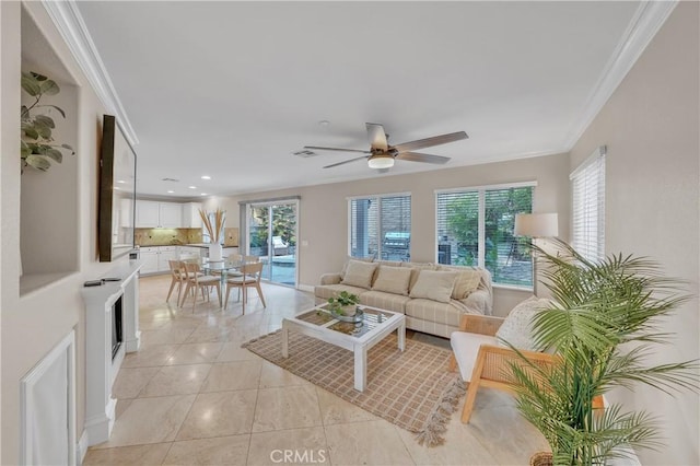 tiled living room featuring ceiling fan and ornamental molding