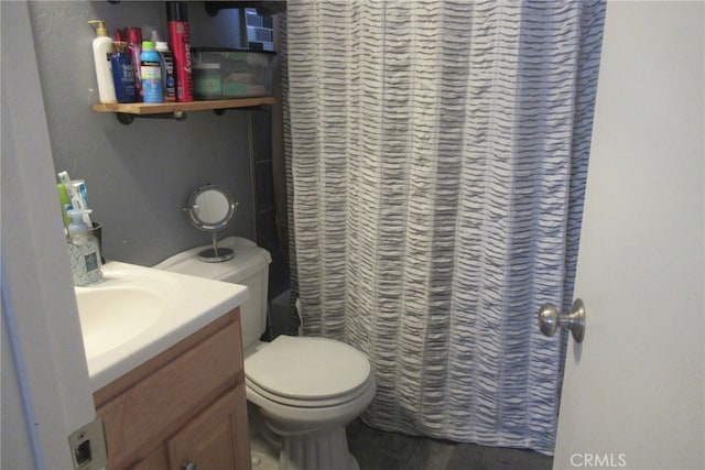 bathroom featuring walk in shower, vanity, and toilet