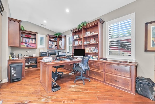 office with lofted ceiling and light hardwood / wood-style floors