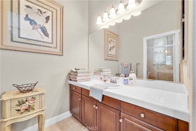 bathroom with tile patterned floors, vanity, and walk in shower