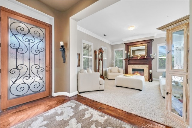 foyer with ornamental molding and hardwood / wood-style flooring