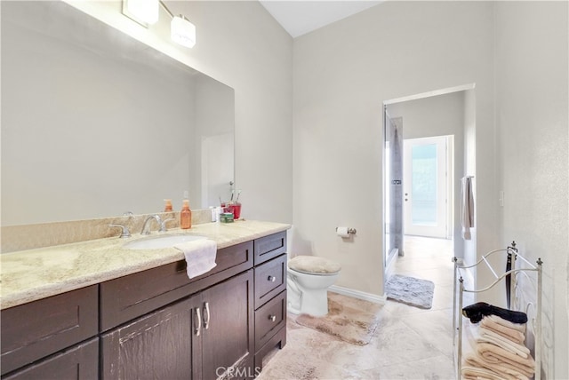 bathroom featuring vanity, tile patterned flooring, and toilet