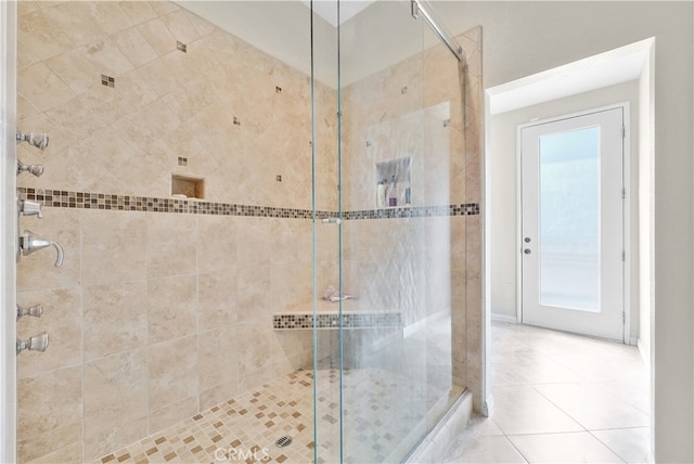 bathroom with tile patterned floors and a shower with shower door