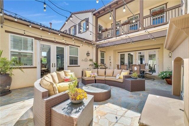 view of patio featuring french doors, a balcony, and an outdoor hangout area