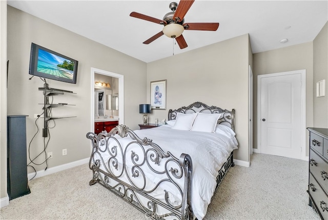 bedroom featuring ceiling fan, light carpet, and ensuite bathroom