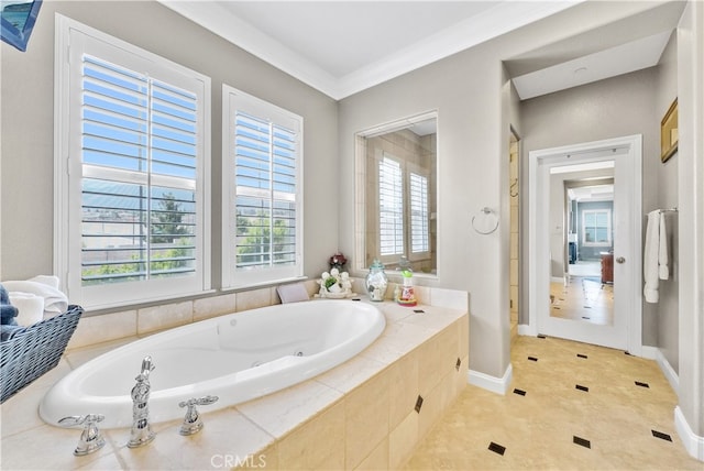 bathroom featuring tiled tub, plenty of natural light, and ornamental molding