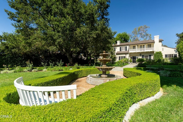 view of property's community with a yard