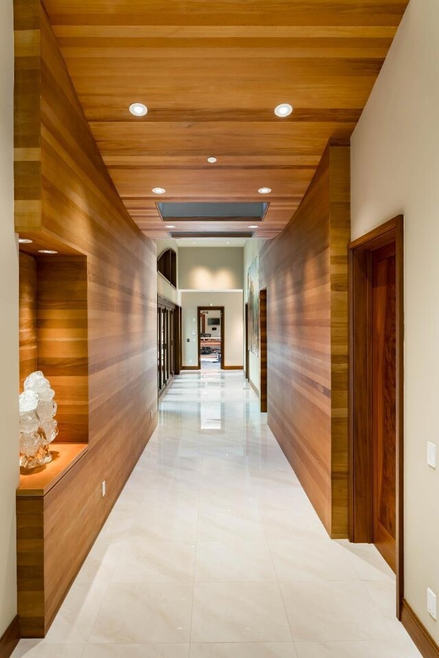 hallway with wood ceiling and wood walls