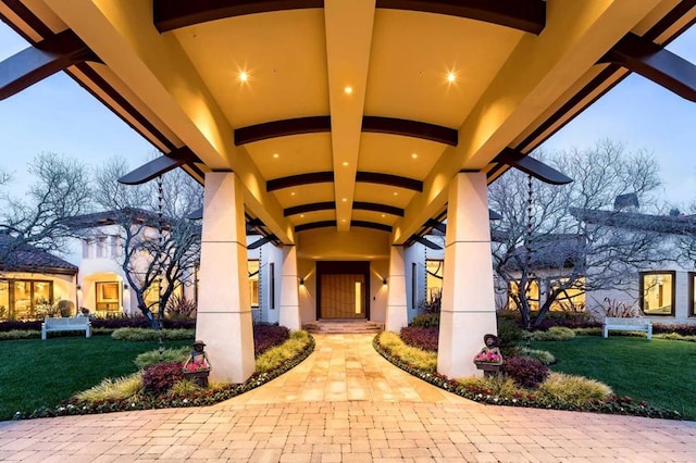 doorway to property featuring a lawn