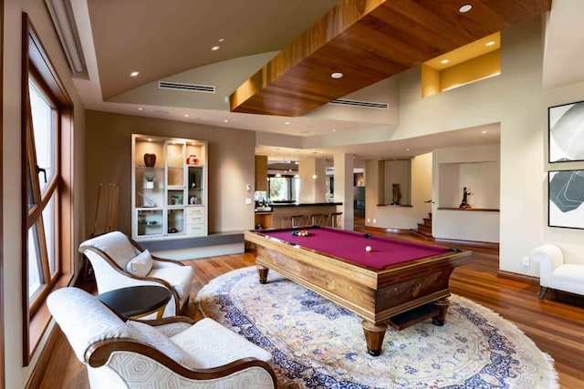 rec room featuring pool table, a towering ceiling, and hardwood / wood-style flooring