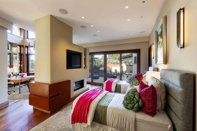 bedroom featuring access to exterior and hardwood / wood-style flooring