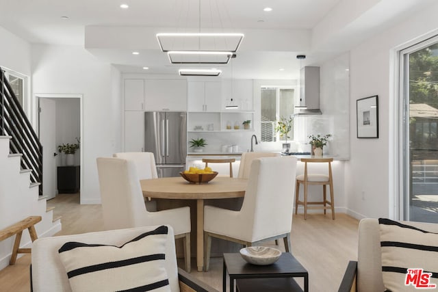 dining space with a chandelier and light wood-type flooring