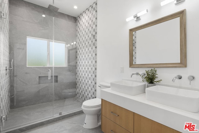 bathroom featuring toilet, an enclosed shower, and vanity