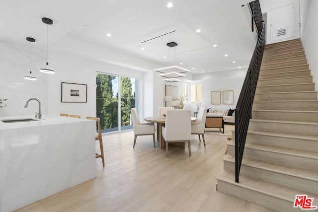 dining space featuring light hardwood / wood-style floors and sink