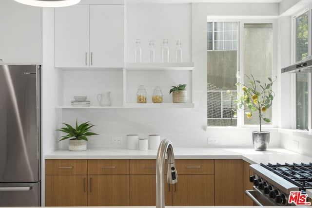 kitchen featuring stainless steel appliances and white cabinets