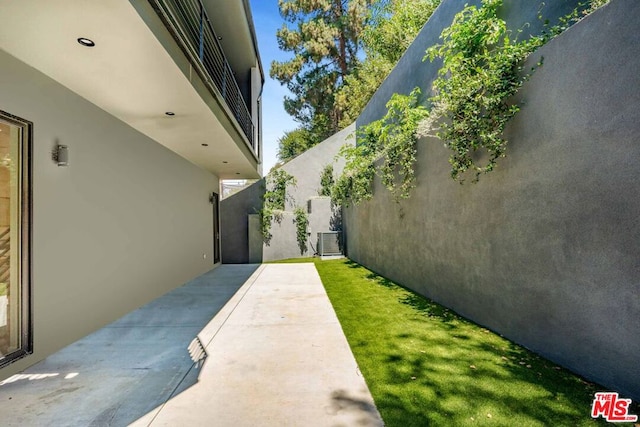 exterior space with a balcony and central air condition unit