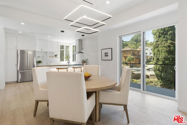 dining room with a chandelier and light wood-type flooring