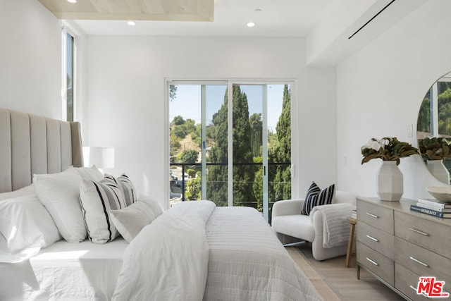 bedroom with light hardwood / wood-style flooring and multiple windows