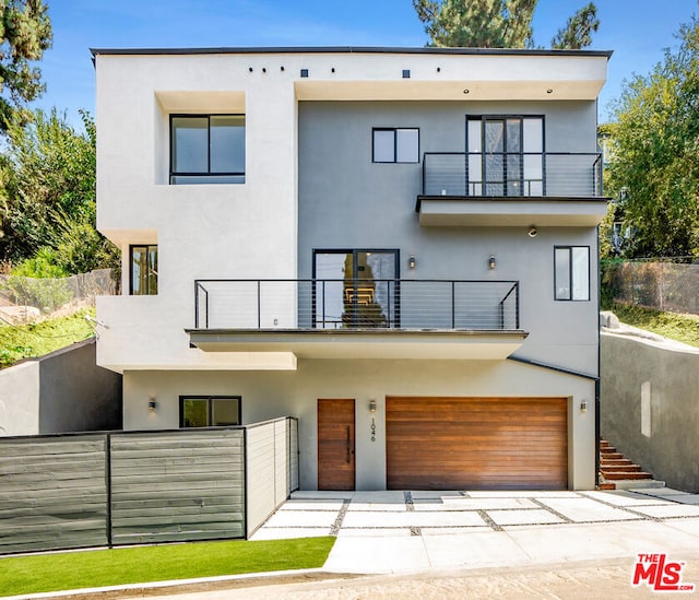 modern home featuring a balcony and a garage