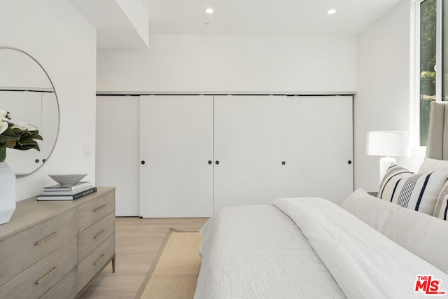 bedroom featuring a closet and light hardwood / wood-style flooring