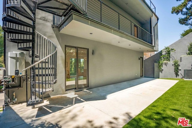 property entrance with a patio and a balcony