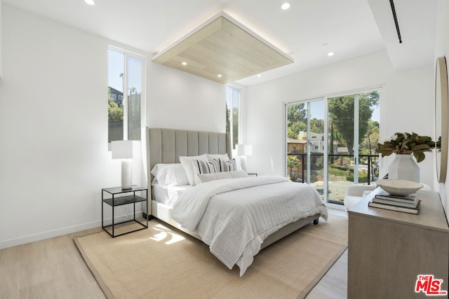 bedroom with light hardwood / wood-style floors and access to outside