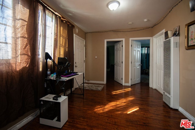 hallway with dark wood-type flooring