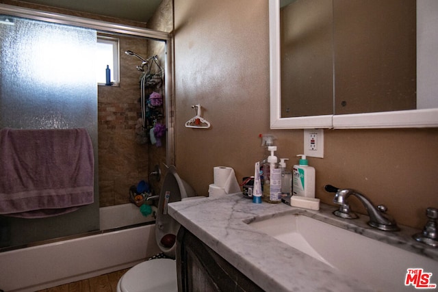 full bathroom with bath / shower combo with glass door, vanity, toilet, and wood-type flooring