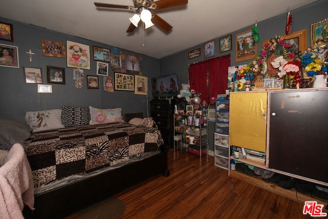 bedroom with ceiling fan and dark hardwood / wood-style flooring