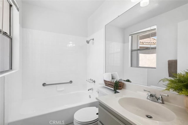 full bathroom with tiled shower / bath combo, toilet, and vanity