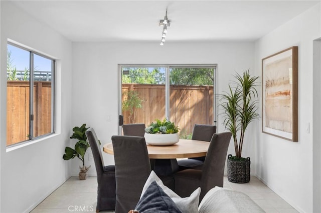 tiled dining space with rail lighting and a wealth of natural light