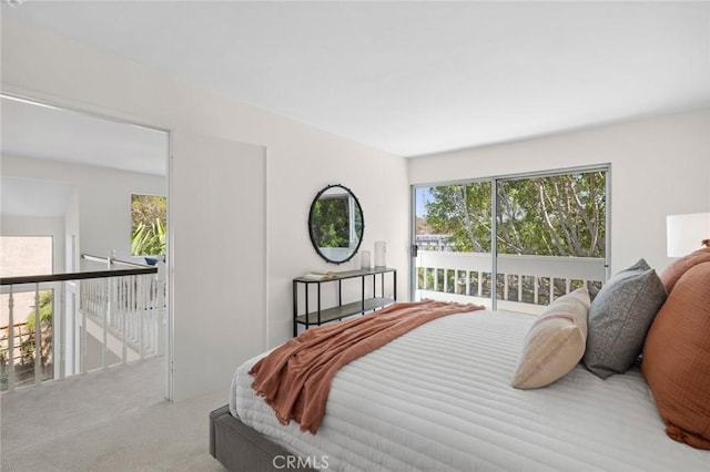 bedroom with access to exterior and light colored carpet