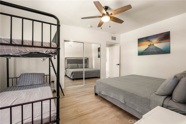 bedroom featuring light hardwood / wood-style flooring, a closet, and ceiling fan