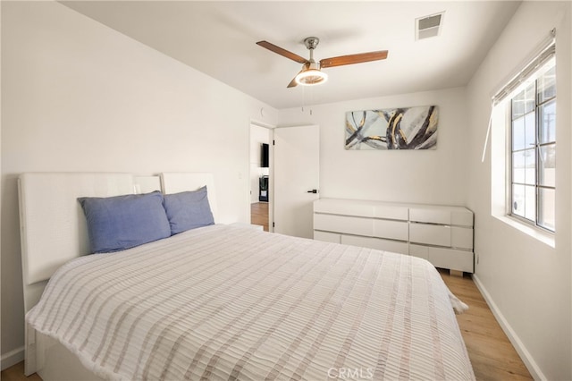 bedroom with light hardwood / wood-style floors and ceiling fan