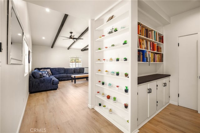 interior space with beamed ceiling and light hardwood / wood-style floors