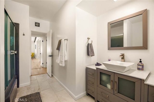 bathroom featuring walk in shower, tile patterned flooring, and vanity