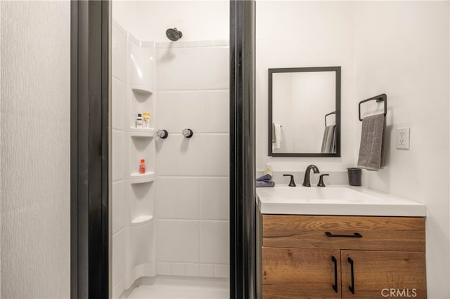 bathroom with walk in shower and vanity