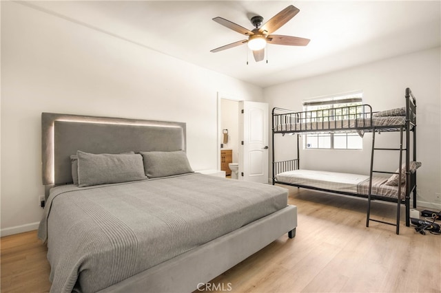 bedroom featuring light wood-type flooring, connected bathroom, and ceiling fan