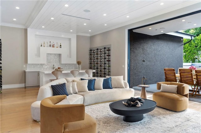 living room featuring crown molding and light hardwood / wood-style floors